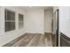 Bright kitchen area with new floors, stainless steel fridge and two large windows at 6350 Akins Way, Cumming, GA 30041