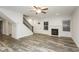 Bright living room with a staircase, fireplace, and new floors at 6350 Akins Way, Cumming, GA 30041