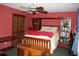Bedroom with red walls, built in shelves, and a ceiling fan at 7240 Colony Ln, Douglasville, GA 30135