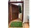 Wooden gate opening up to a stone path and manicured evergreens at 7248 Mountain Laurel Way, Stockbridge, GA 30281