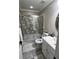 Updated bathroom with a glass enclosed shower and gray/white marble flooring at 7248 Mountain Laurel Way, Stockbridge, GA 30281