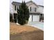 Charming two-story home with stone accents, a two-car garage, and a well-manicured lawn at 7248 Mountain Laurel Way, Stockbridge, GA 30281