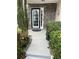Welcoming front entrance featuring a black-framed door, stone accents, and manicured landscaping at 7248 Mountain Laurel Way, Stockbridge, GA 30281