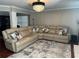 Bright living room featuring a beige sectional sofa and decorative rug at 7248 Mountain Laurel Way, Stockbridge, GA 30281