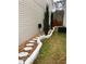 Well-maintained side yard with river rock, stone path, and manicured evergreens at 7248 Mountain Laurel Way, Stockbridge, GA 30281