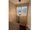 Carpeted staircase with an updated light fixture and natural light at 7248 Mountain Laurel Way, Stockbridge, GA 30281