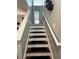 Carpeted staircase leads to the upper level with decorative shelving on the wall at 7248 Mountain Laurel Way, Stockbridge, GA 30281