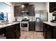 Well-equipped kitchen with granite countertops, stainless steel appliances, and dark wood cabinetry at 824 Drumore Ct, Fairburn, GA 30213