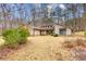 This home features mature landscaping, modern windows, and a unique roofline at 221 Shadowood Ln, Peachtree City, GA 30269