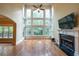 Soaring two-story Gathering room, fireplace, and a wall of windows overlooking the backyard at 204 Fernwood Pl, Woodstock, GA 30188