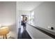 Hallway with hardwood floors, gray trim, and natural light leading into a bright bedroom area at 4236 Deming Cir, Atlanta, GA 30342