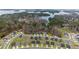 An aerial view of a quiet neighborhood surrounded by green trees and a beautiful view of the lake at 6451 Crest Brook Way, Buford, GA 30518