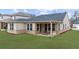 Spacious backyard with a covered patio, providing a great space for relaxation and entertainment at 6451 Crest Brook Way, Buford, GA 30518