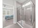 Modern bathroom with a glass shower, tiled walls, and access to the bedroom at 6451 Crest Brook Way, Buford, GA 30518