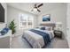 Relaxing bedroom features large windows and a ceiling fan. The room has soft carpet and light-colored walls at 6451 Crest Brook Way, Buford, GA 30518