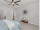 Spacious bedroom featuring a ceiling fan, neutral paint, and a cozy bench at 6451 Crest Brook Way, Buford, GA 30518