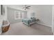 Bright bedroom with large window, ceiling fan, and neutral carpet and paint colors at 6451 Crest Brook Way, Buford, GA 30518