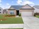Charming single-story brick home with a well-maintained lawn and attached two-car garage at 6451 Crest Brook Way, Buford, GA 30518