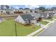 Beautiful aerial view of home showcasing manicured lawn, brick exterior, and desirable neighborhood setting at 6451 Crest Brook Way, Buford, GA 30518