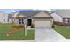 Charming brick home with a well-maintained lawn, inviting curb appeal, and a two-car garage at 6451 Crest Brook Way, Buford, GA 30518