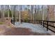 Private fire pit area surrounded by black fencing and gravel, offering a tranquil outdoor space at 6451 Crest Brook Way, Buford, GA 30518