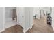 Hallway and bathroom with tile floors and neutral colors. The hallway leads to the common areas at 6451 Crest Brook Way, Buford, GA 30518