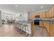Kitchen area with light wood cabinets, granite countertops, stainless appliances and eat in island at 6451 Crest Brook Way, Buford, GA 30518