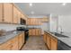 Updated kitchen with wooden cabinets, granite counters, stainless steel appliances and matching hard wood floors at 6451 Crest Brook Way, Buford, GA 30518