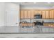 Spacious kitchen with granite countertops, stainless appliances, and ample cabinet space at 6451 Crest Brook Way, Buford, GA 30518