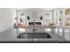 Bright, open-concept living room with a fireplace viewed from the kitchen sink at 6451 Crest Brook Way, Buford, GA 30518