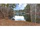 Picturesque lake view with a dock and boats, providing access to water activities and scenic beauty at 6451 Crest Brook Way, Buford, GA 30518