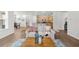 Open living area into kitchen featuring hard wood floors and comfy couch at 6451 Crest Brook Way, Buford, GA 30518