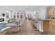 Open concept living area with a modern kitchen island, fireplace, and comfortable seating at 6451 Crest Brook Way, Buford, GA 30518