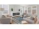 Bright living room features a modern fireplace, comfortable seating, and ample natural light at 6451 Crest Brook Way, Buford, GA 30518