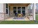 Charming covered patio area with outdoor seating, perfect for enjoying outdoor living at 6451 Crest Brook Way, Buford, GA 30518