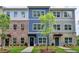 Beautiful townhome exteriors feature colorful facades, manicured lawns, and inviting walkways at 5473 Blossomwood Sw Trl, Mableton, GA 30126