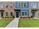 Townhome's charming exterior boasts colorful facades, fresh lawns, and welcoming sidewalks at 5473 Blossomwood Sw Trl, Mableton, GA 30126
