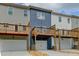 Townhome exterior featuring garages and elevated decks, offering a blend of convenience and outdoor living at 5473 Blossomwood Sw Trl, Mableton, GA 30126