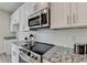 Updated kitchen features granite counters, stainless appliances, and white subway tile backsplash at 5473 Blossomwood Sw Trl, Mableton, GA 30126