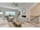 Open-concept living room boasts a ceiling fan, fireplace, and stairs to the second floor at 5473 Blossomwood Sw Trl, Mableton, GA 30126
