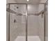 Elegant glass-enclosed shower includes a built-in niche and tiled walls at 5473 Blossomwood Sw Trl, Mableton, GA 30126