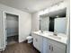 Bathroom with dual sink vanity, modern fixtures and a walk-in closet with shelving at 5477 Blossomwood Sw Trl, Mableton, GA 30126