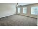 Carpeted bedroom features three bright windows and a ceiling fan at 5477 Blossomwood Sw Trl, Mableton, GA 30126