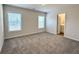 Carpeted bedroom features two bright windows and access to a private bathroom at 5477 Blossomwood Sw Trl, Mableton, GA 30126