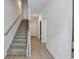 Welcoming entryway featuring hardwood floors, a staircase, and fresh, neutral paint at 5477 Blossomwood Sw Trl, Mableton, GA 30126