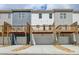Townhome garages and decks in a row with stone landscaping at 5477 Blossomwood Sw Trl, Mableton, GA 30126