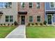 Close-up of a townhome front yard with landscaping leading to the front door at 5477 Blossomwood Sw Trl, Mableton, GA 30126