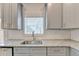 Modern kitchen features granite counters, subway tile backsplash, stainless steel sink and stylish gray cabinets at 5477 Blossomwood Sw Trl, Mableton, GA 30126