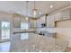 Modern kitchen with granite counters, stainless appliances, and sleek gray cabinetry at 5477 Blossomwood Sw Trl, Mableton, GA 30126