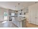 Beautiful kitchen featuring a large island, modern fixtures, and light-colored cabinets at 5477 Blossomwood Sw Trl, Mableton, GA 30126